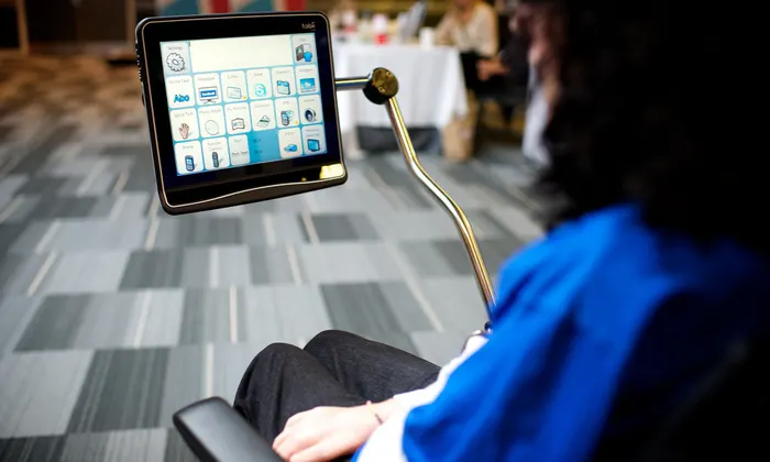 Woman in a wheelchair uses eye gaze technology to navigate her chair